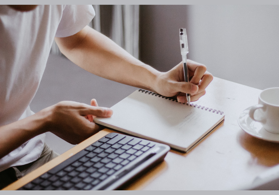 young man taking notes during listening coaching